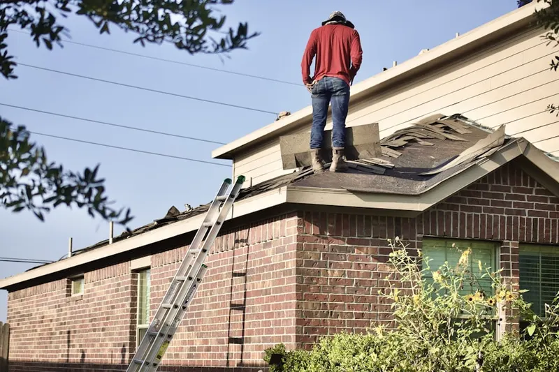 Professional roofer working on a residential roof in Conover